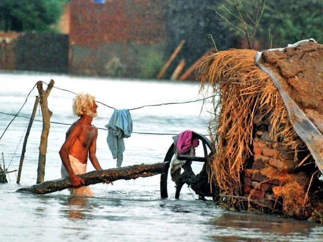 a man stands in front of his house submerged in floodwater in sargodha photo muhammad farooq express a man stands in front of his house submerged in floodwater in sargodha photo muhammad farooq express