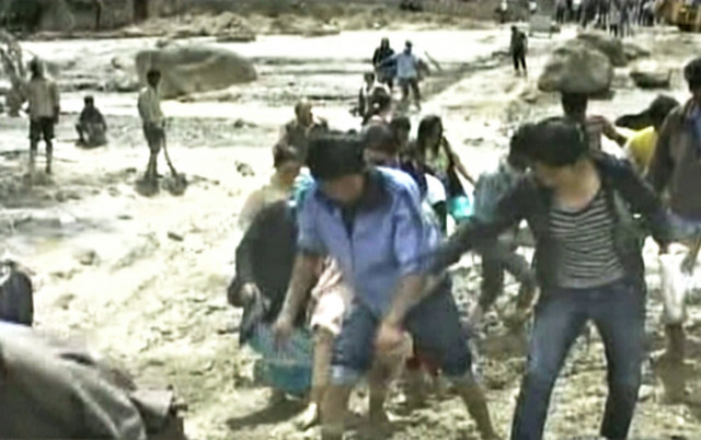 a television grab shows flood affected residents walking through thick mud following flash floods in leh photo afp ndtv a television grab shows flood affected residents walking through thick mud following flash floods in leh photo afp ndtv