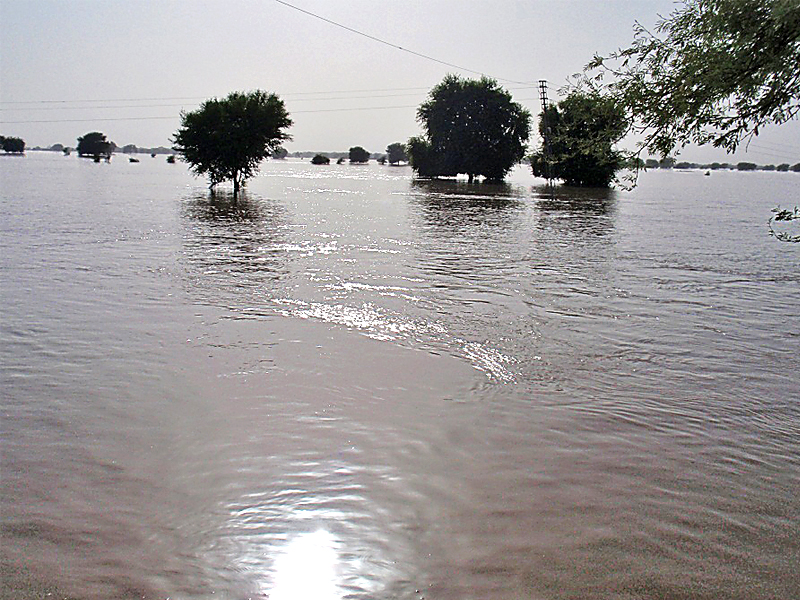 a number of villagers sitting on a boat as the katcha areas from rohri to pano aqil are submerged in floodwater that has flowed down from the punjab where torrential rains hit last week photo express