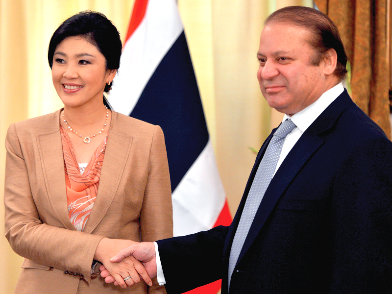 prime minister nawaz sharif shaking hands with his thai counterpart yingluck shinawatra before their talks in islamabad photo afp