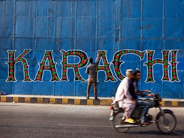 a street artist applies the final touches to a mural part of the 039 i am karachi 039 campaign as a motorcycle passes by in karachi pakistan on friday may 29 2015 pakistan 039 s budget is scheduled to be presented on june 5 photo getty