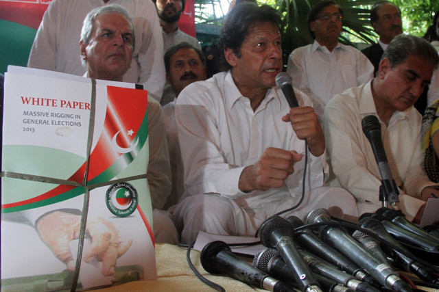 pti chairman imran khan c unveils his party 039 s white paper on wednesday with senior party leader javed hasmi l photo zafar islam express