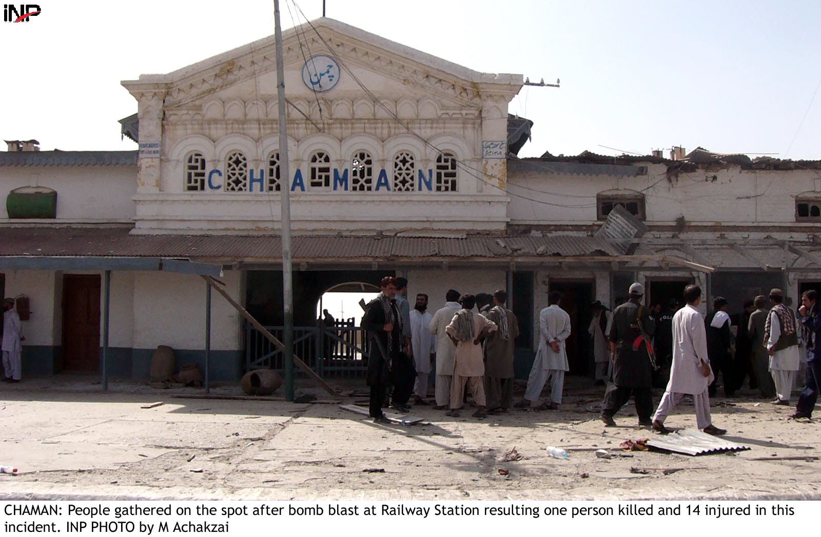 security forces and people gathered at the site of a blast at the chaman railway station photo inp