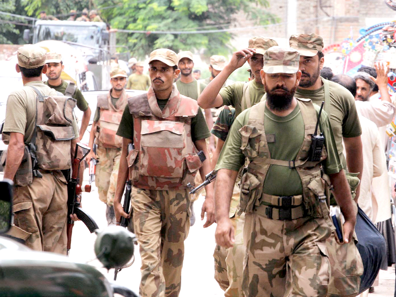 army troops being deployed at polling stations in peshawar to ensure peaceful conduct of by polls photo inp