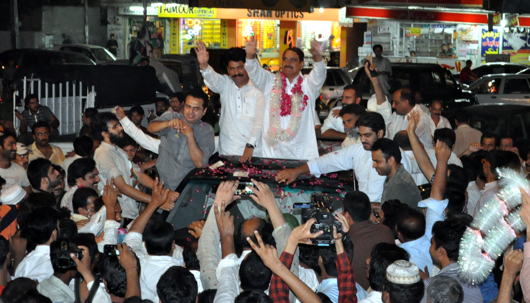 pml n 039 s abdul mannan celebrates with supporters after winning the na 83 seat in faisalabad in the by elections of august 22