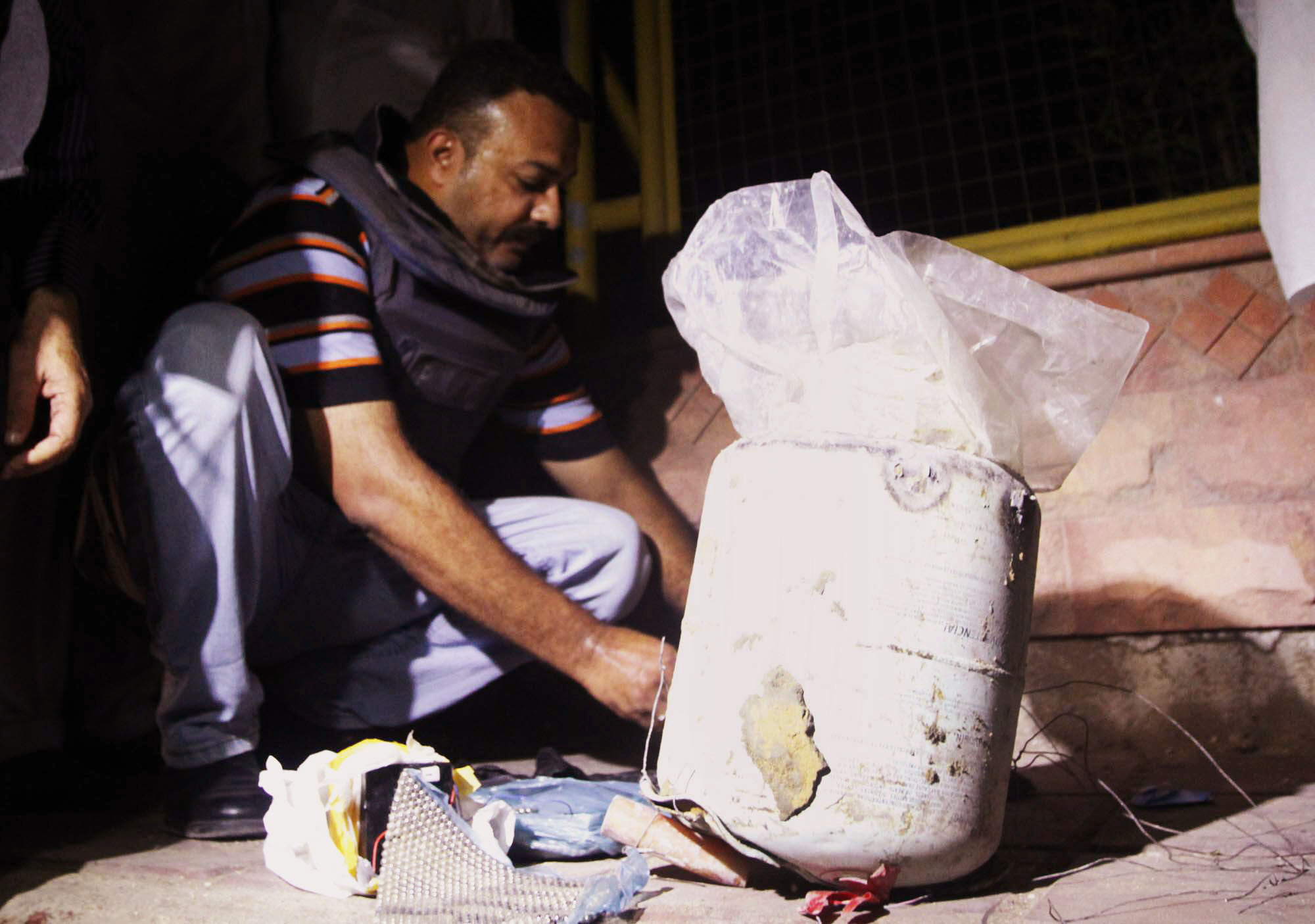 a bomb disposal squad member defuses an explosive device found near the site of a bomb outside the rangers headquarters in korangi on thursday photo mohammad azeem express