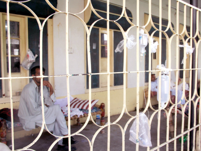 patients sit outside the medical ward on rented beds which cost rs50 each photo express