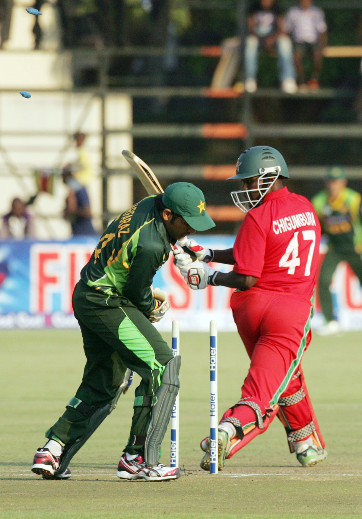 zimbabwe batsman elton chigumbura r loses his wicket as wicket keeper sarfraz ahmed looks on photo afp