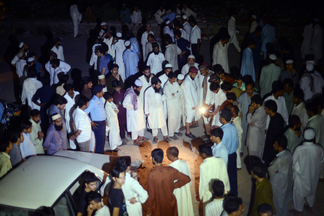 people gathered after two men riding a motorcycle opened fire in front of the jamia madrassah madinatul uloom a religious seminary located on the service road near khanna pul photo afp people gathered after two men riding a motorcycle opened fire in front of the jamia madrassah madinatul uloom a religious seminary located on the service road near khanna pul photo afp