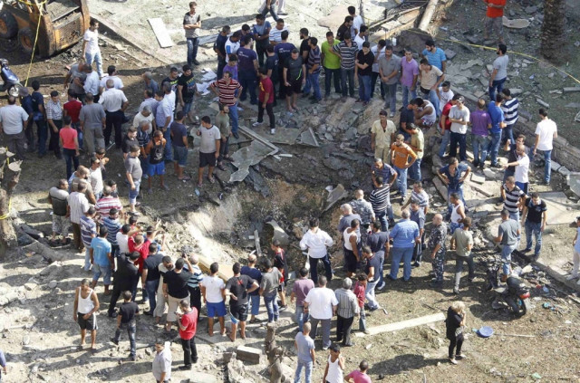 residents gather around a crater caused by one of the two explosions outside one of two mosques in lebanon 039 s northern city of tripoli august 23 2013 photo reuters residents gather around a crater caused by one of the two explosions outside one of two mosques in lebanon 039 s northern city of tripoli august 23 2013 photo reuters