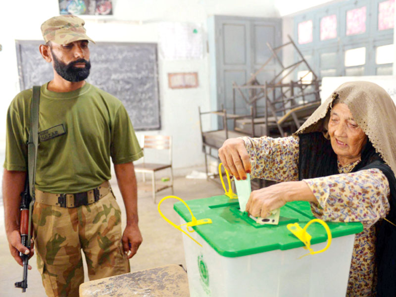 an elderly voter casts her ballot during the by election in peshawar photo afp