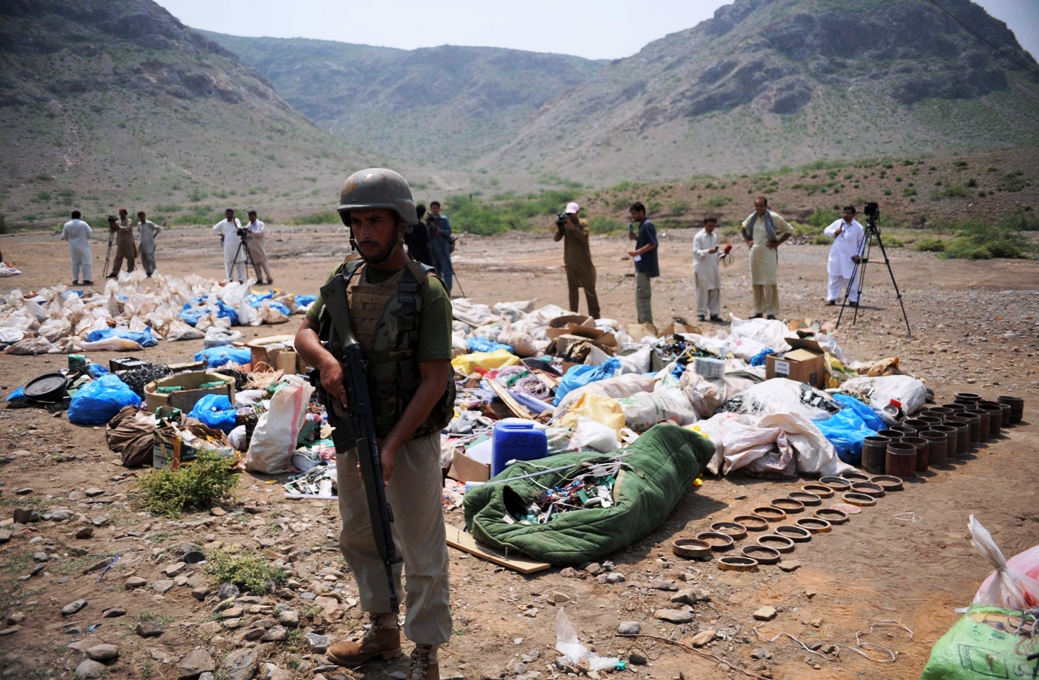 paramilitary soldiers and media stand near seized bomb making material in shahkas village in khyber district close to peshawar on august 25 2013 photo afp