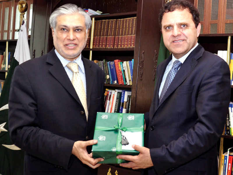 finance minister ishaq dar presents a souvenir to his afghan counterpart dr hazrat omer zakhiwal prior to a meeting on sunday photo inp