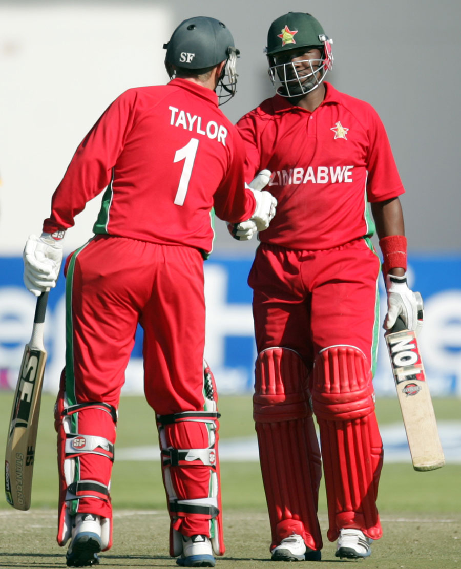 captain brendan taylor congratulates hamilton masakadza right on completing his half century photo afp