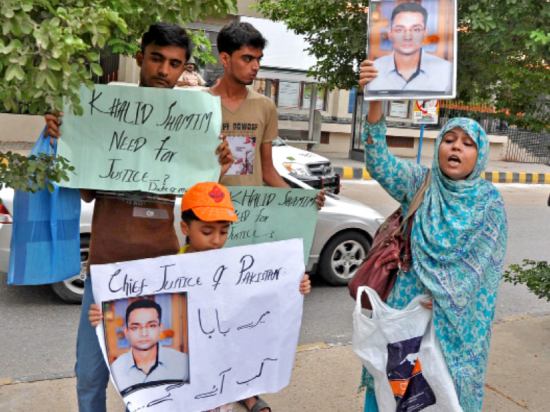 families of missing persons held placards on the route of chief justice iftikhar chaudhry as his entourage made its way towards the supreme court karachi registry photo express