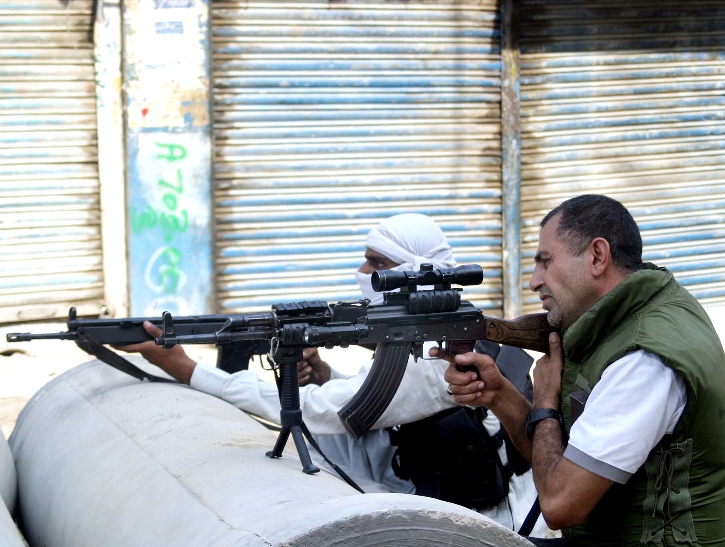 two plain clothes policemen take part in an operation in karachi photo ppi file