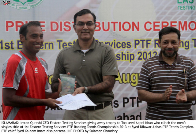 ceo eastern testing services imran qureshi gives the trophy to tennis top seed aqeel khan photo inp ceo eastern testing services imran qureshi gives the trophy to tennis top seed aqeel khan photo inp