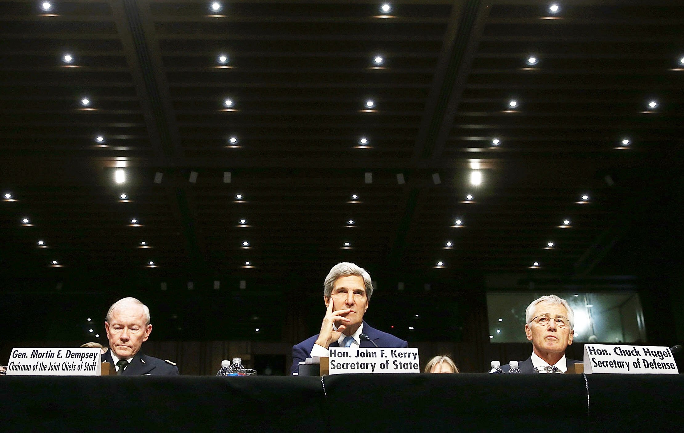 us secretary of state john kerry c sits along with us joint chiefs of staff martin dempsy l and secretary of defence chuck hagel r before the senate commitee photo afp