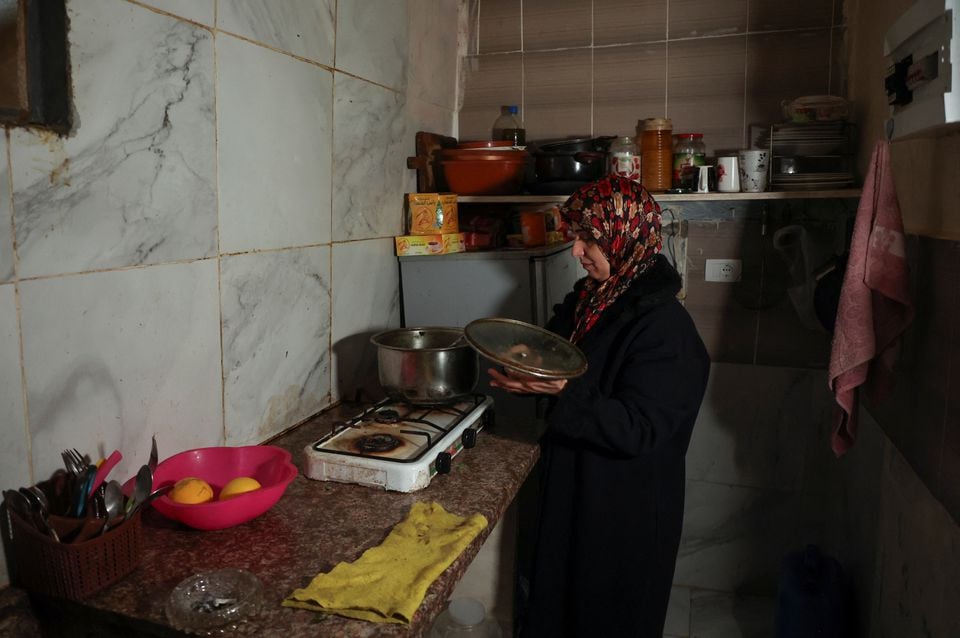 Wife of unemployed Lebanese Hussein Hamadeh stands at the kitchen of her home in Beirut's southern suburb of Ouzai, Lebanon November 15, 2022. REUTERS/Mohamed Azakir