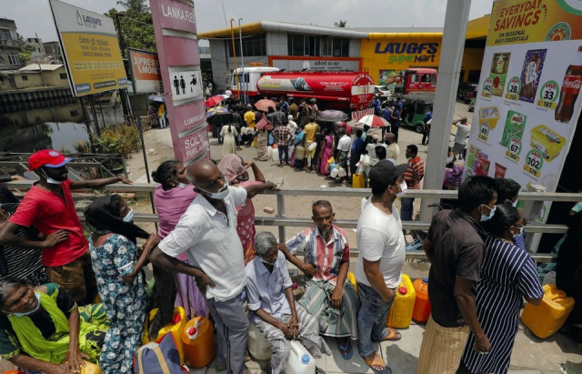 people stand in a long queue to buy kerosene oil for kerosene cookers amid a shortage of domestic gas due to country s economic crisis at a fuel station in colombo sri lanka march 21 2022 reuters people stand in a long queue to buy kerosene oil for kerosene cookers amid a shortage of domestic gas due to country s economic crisis at a fuel station in colombo sri lanka march 21 2022 reuters