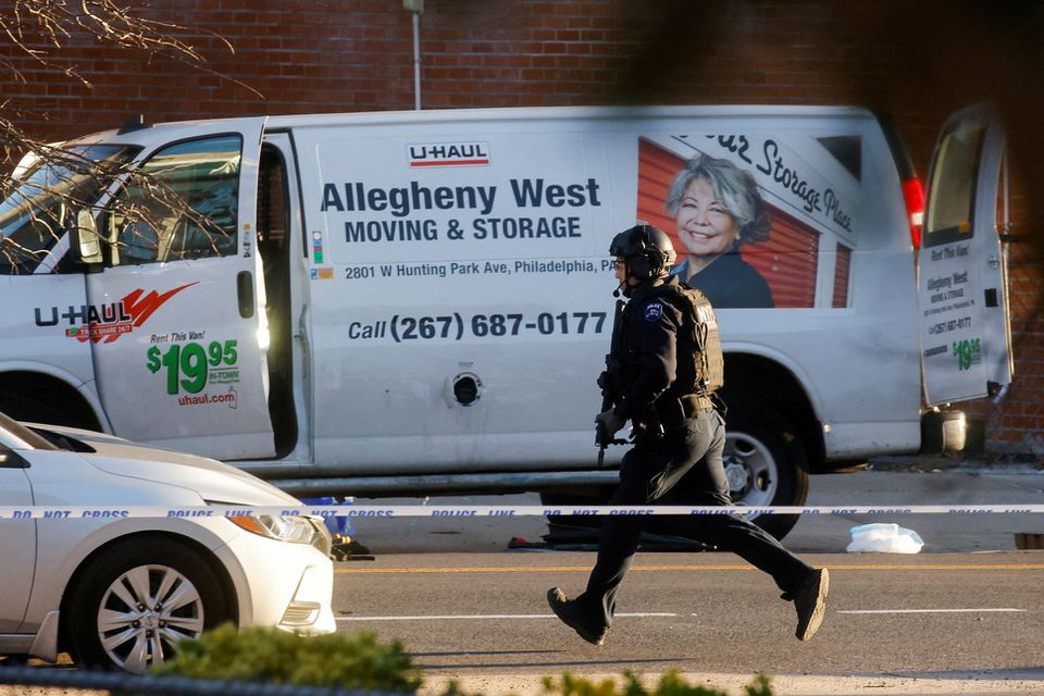 a police officer runs near a van that police say is connected with the shooting at a subway station in the brooklyn borough of new york city new york u s april 12 2022 reuters