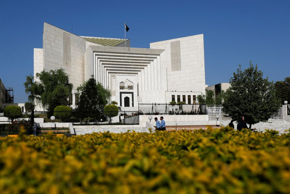 police officers walk past the supreme court of pakistan building in islamabad pakistan april 6 2022 photo reuters