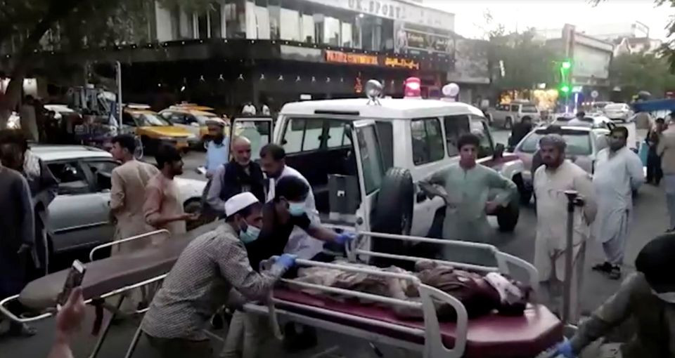 A screen grab shows people carrying an injured person to a hospital after an attack at Kabul airport, in Kabul, Afghanistan August 26, 2021. PHOTO: REUTERS