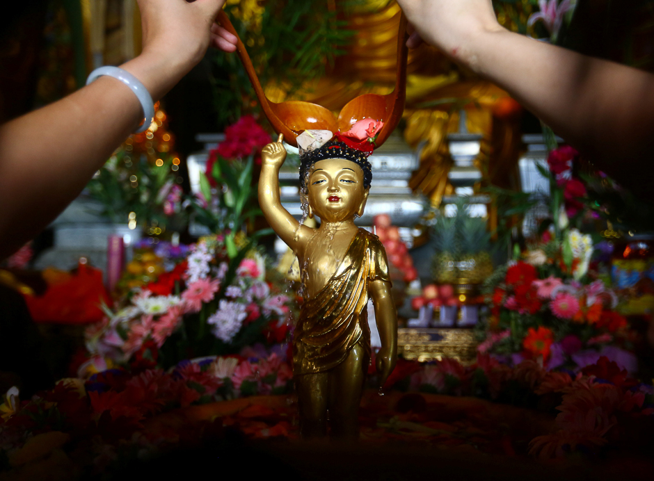 People pour water onto a Buddha statue during a celebration event for Buddha's birthday in Sanya, Hainan province, China. PHOTO: REUTERS