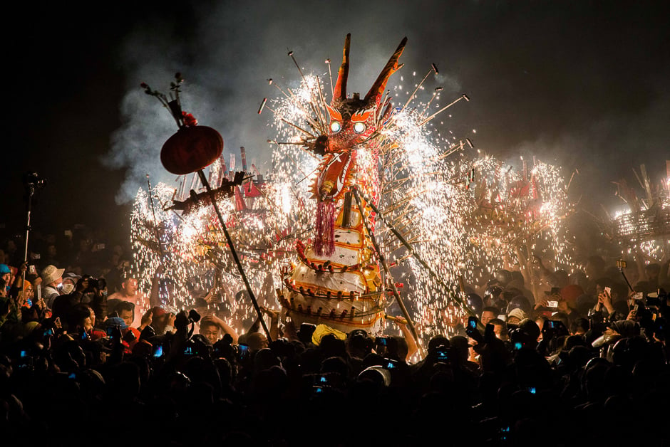 People watch a fire dragon made of lantern, firecrackers and fireworks as people perform a dragon dance to celebrate Lantern Festival in Fengshun county, Guangdong province. PHOTO: REUTERS