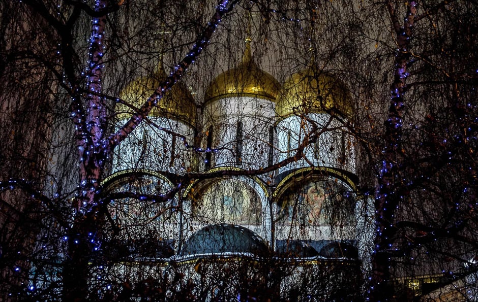 A Kremlin cathedral is seen behind illuminated trees in downtown Moscow. PHOTO: AFP