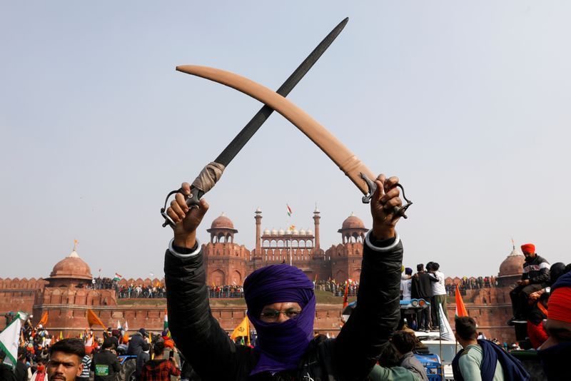 a farmer holds a sword during a protest against farm laws introduced by the government at the historic red fort in delhi india january 26 2021 reuters