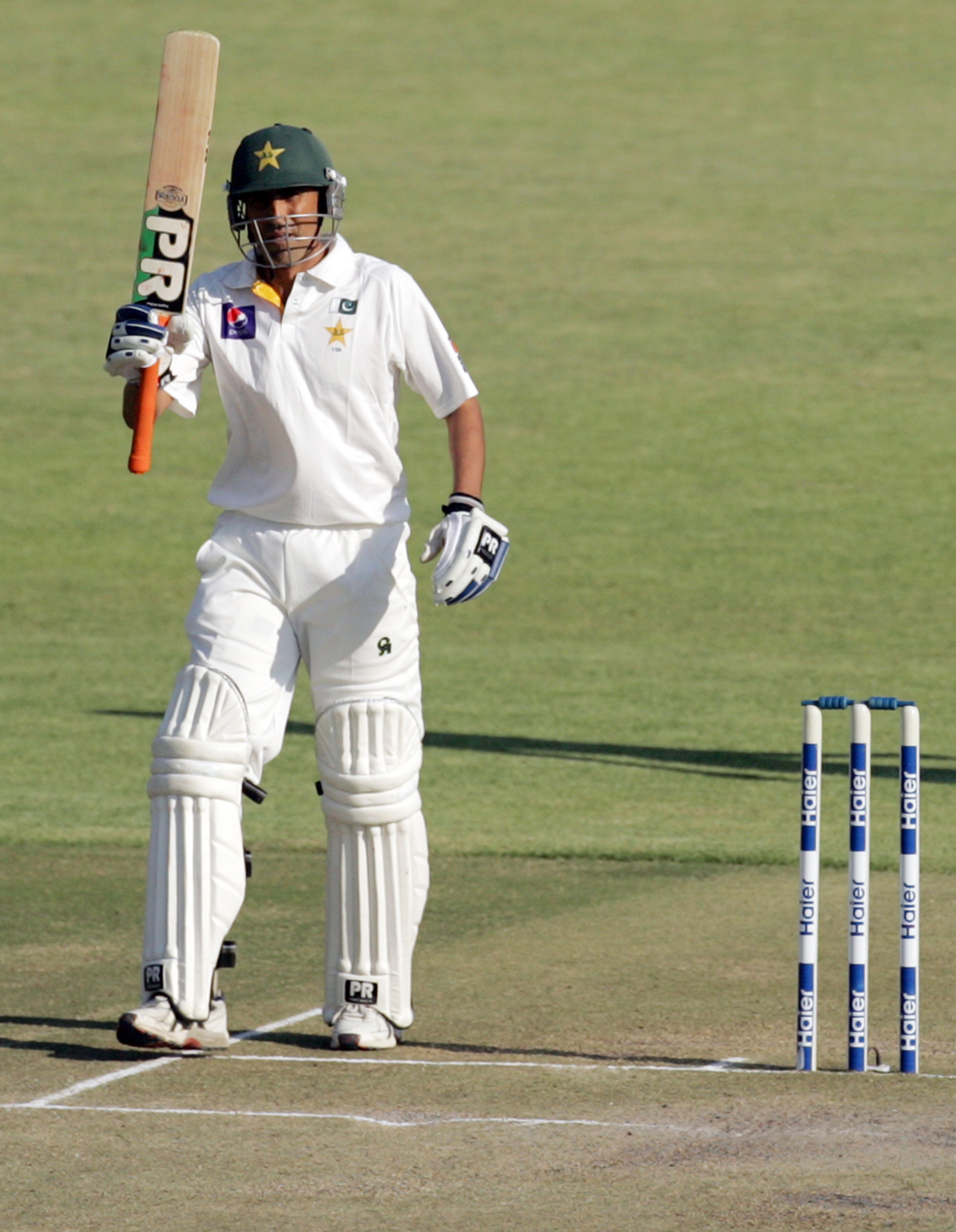 younis khan raises his bat after reaching a half century on september 5 2013 during the third day of the first test against zimbabwe at the harare sports club photo afp