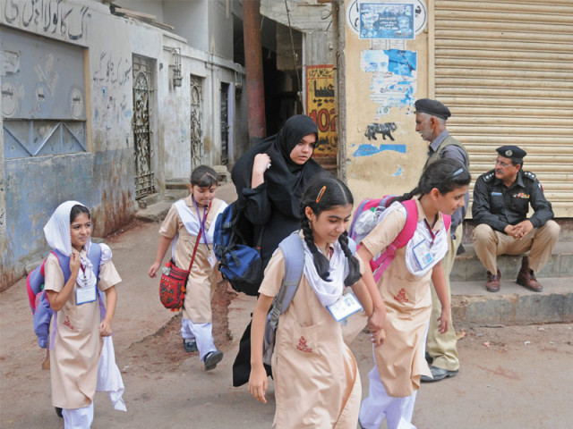 a group of school children dodge their way through the law enforcers who were conducting an operation in chanesar goth on thursday morning photo muhammad azeem express a group of school children dodge their way through the law enforcers who were conducting an operation in chanesar goth on thursday morning photo muhammad azeem express
