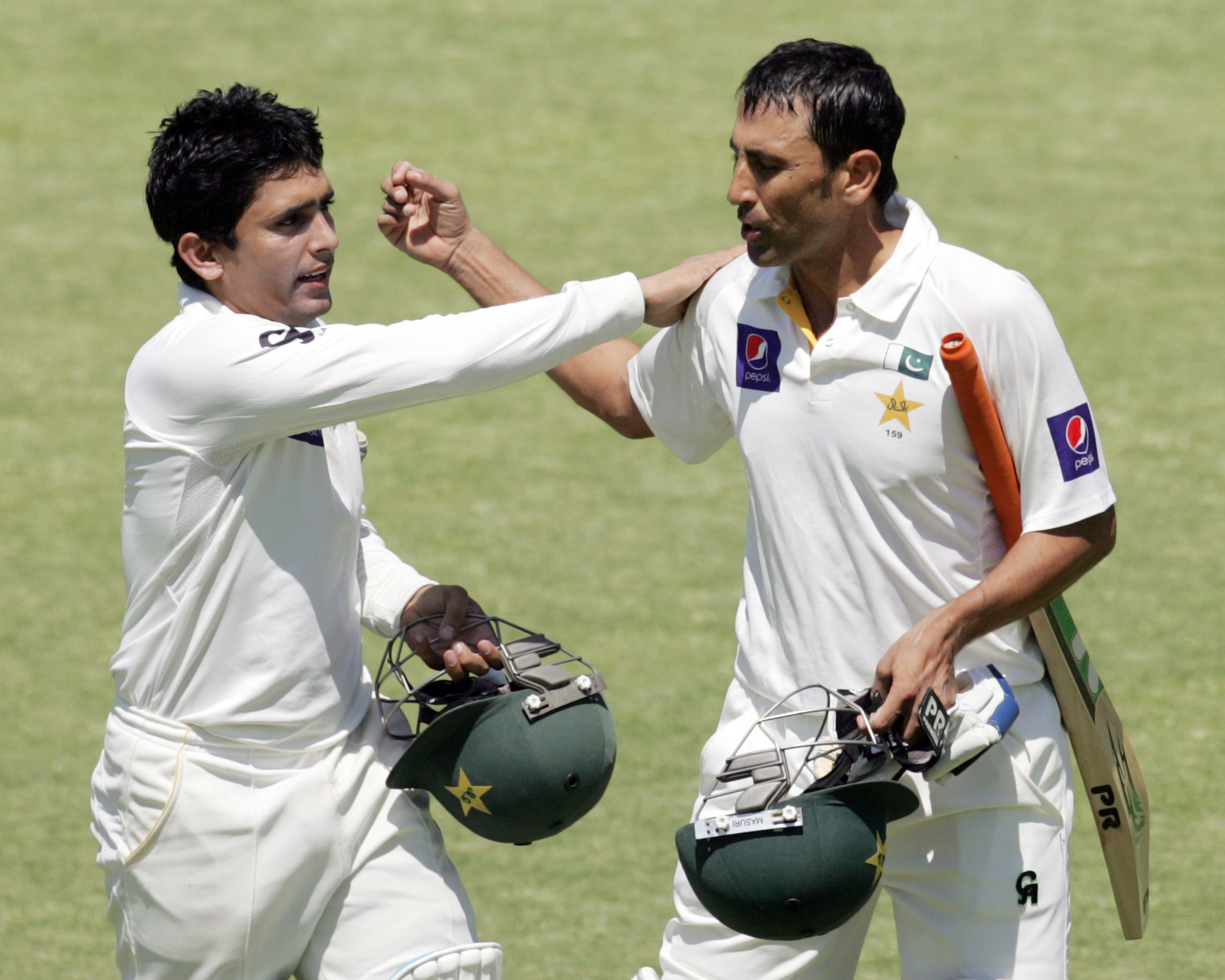 pakistan 039 s batsman younis khan r is congratulated by pakistan 039 s batsman adnan akmal l before walking from the pitch at tea break during the fourth day of the first cricket test match between pakistan and hosts zimbabwe at the harare sports club september 6 2013 photo afp