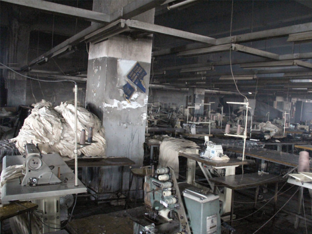 the sewing floor of the garment factory was charred in the fire that took the lives of over 250 workers even though there is a fire extinguisher the factory lacked proper fire exits photo file the sewing floor of the garment factory was charred in the fire that took the lives of over 250 workers even though there is a fire extinguisher the factory lacked proper fire exits photo file