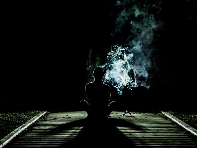 faking a smile the burnt cigarette leaving its mark photo pexels