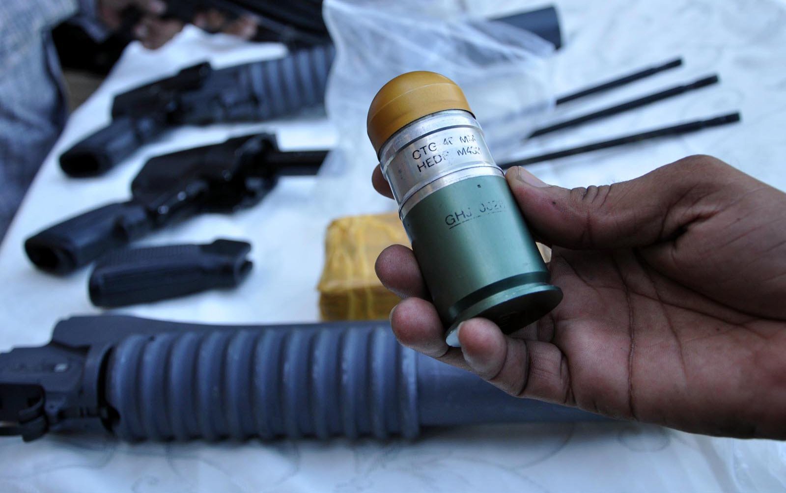 south police official displaying the rocket launchers recovered after raid in zamzama police said the weapons were being delivered to a shop photo inp