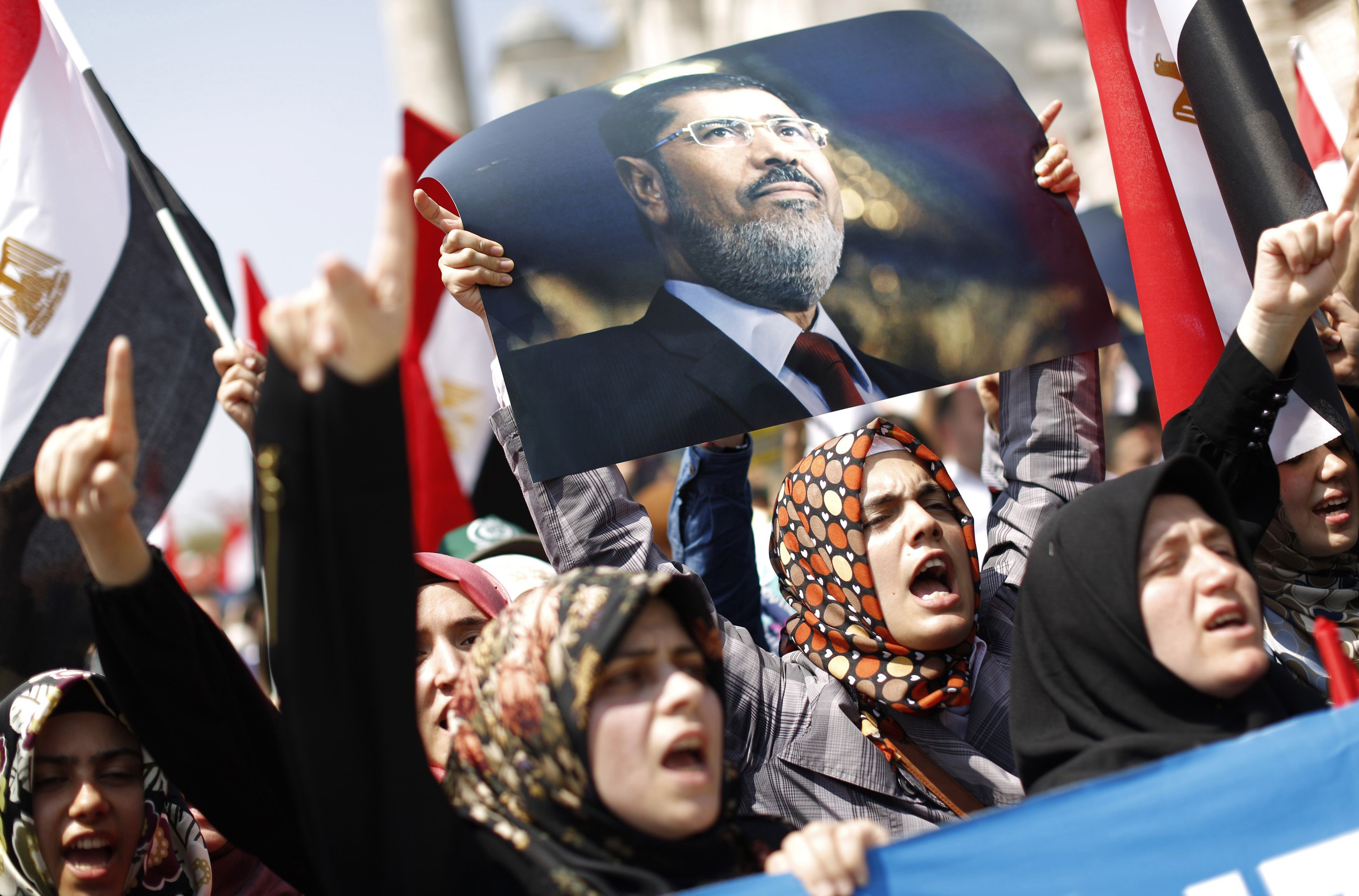 file photo of pro mursi demonstrators holding egyptian flags and a poster of deposed president mohamed mursi photo reuters file