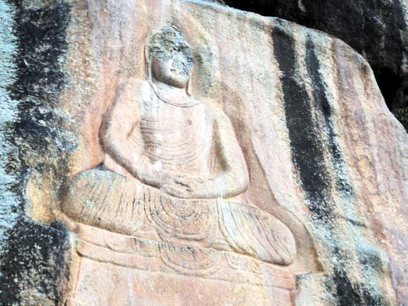 a rock carving of buddha at jahanabad photo fazal khaliq express