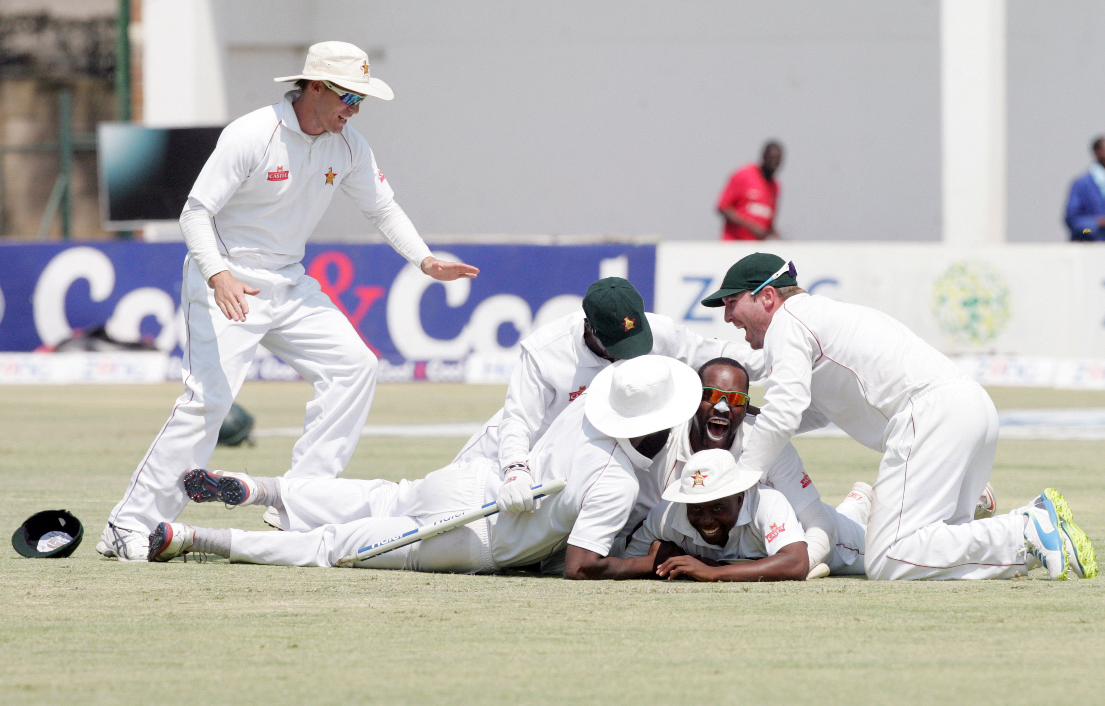 zimbabwe players are ecstatic after running out pakistan 039 s last player photo afp