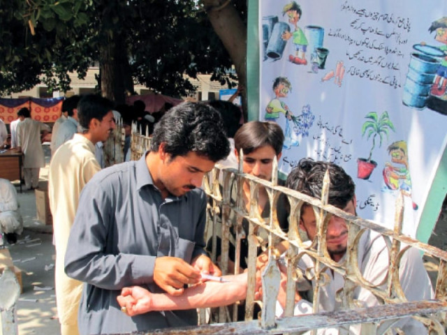 a paramedic takes blood sample from a man at saidu teaching hospital in the open air without adopting sanitary precautions the dengue outbreak in swat district has so far claimed 11 lives while thousands are infected photo inp a paramedic takes blood sample from a man at saidu teaching hospital in the open air without adopting sanitary precautions the dengue outbreak in swat district has so far claimed 11 lives while thousands are infected photo inp