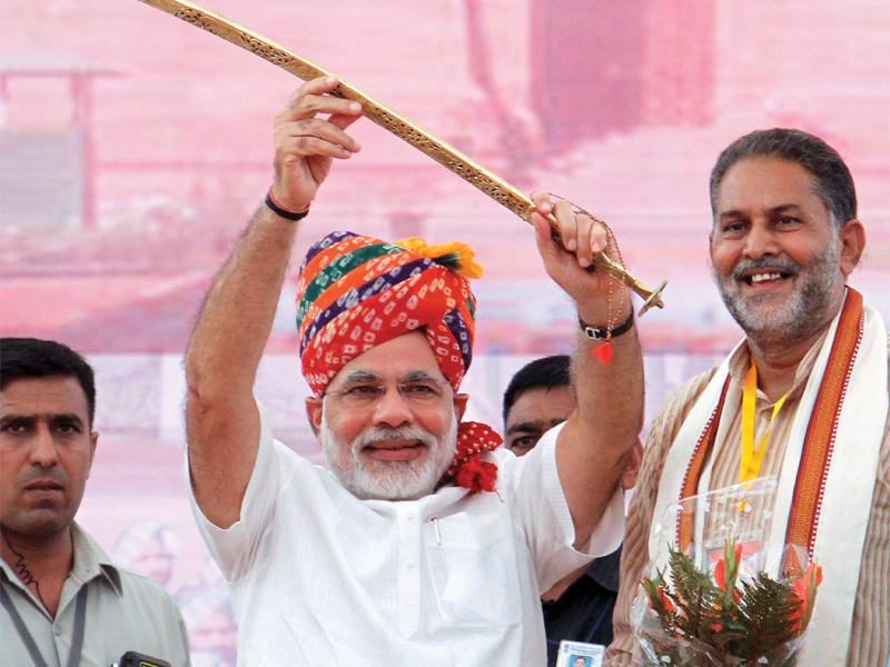 gujarat chief minister narendra modi raises a sword at bharatiya janata party rally after being named a prime ministerial candidate for elections due next year photo afp