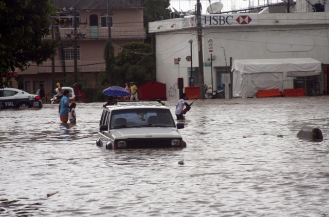 a car sits in a flooded street as people make their way through in acapulco september 15 2013 photo reuters a car sits in a flooded street as people make their way through in acapulco september 15 2013 photo reuters