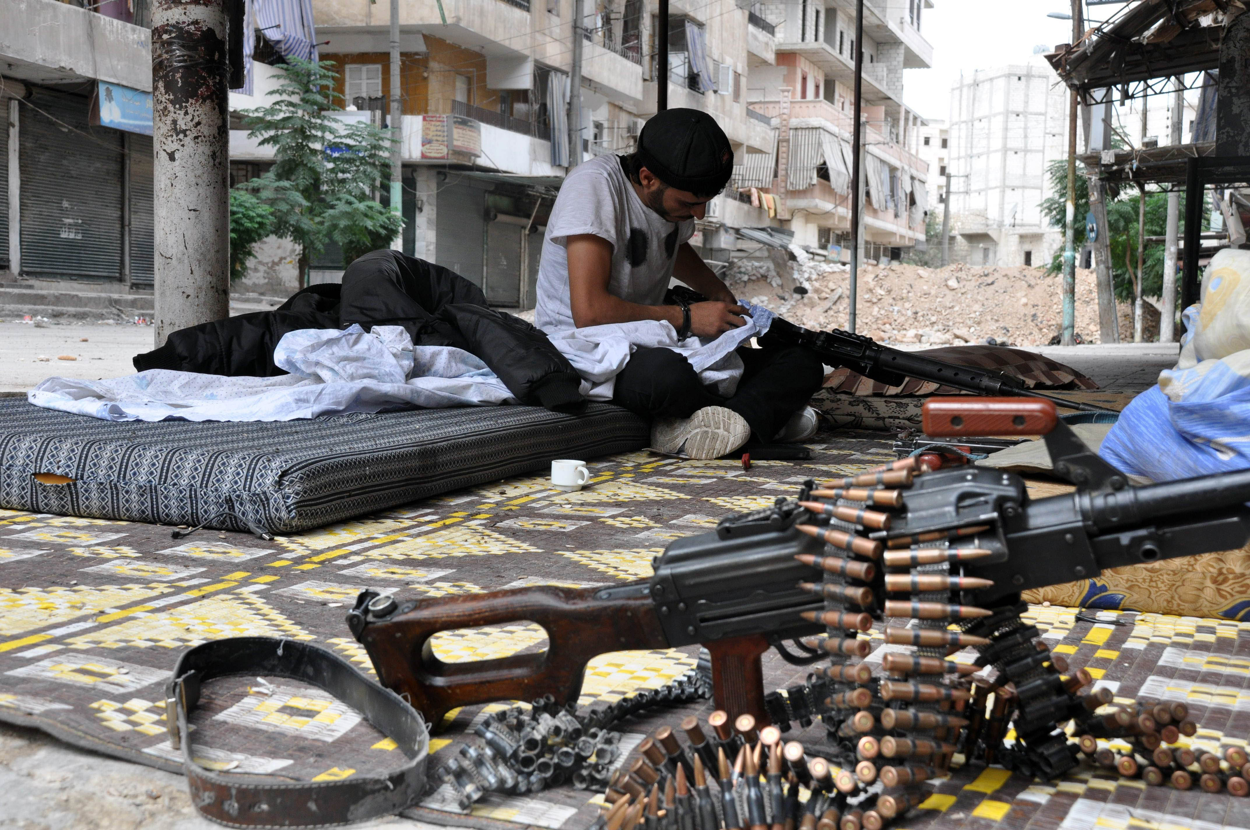 a rebel fighter cleans his weapon in the northern syrian city of aleppo on september 20 2013 syrian rebels have agreed a ceasefire with al qaeda loyalists after bitter fighting for a key border town photo afp