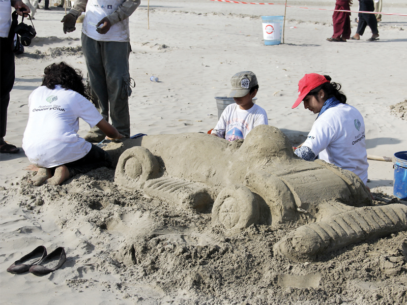 children build a race car out of sand on sunday in the third sandcastle building competition at sea view clifton organsied by let s build on this competition is part of their activity to create awareness about keeping beaches clean photo ayesha mir express