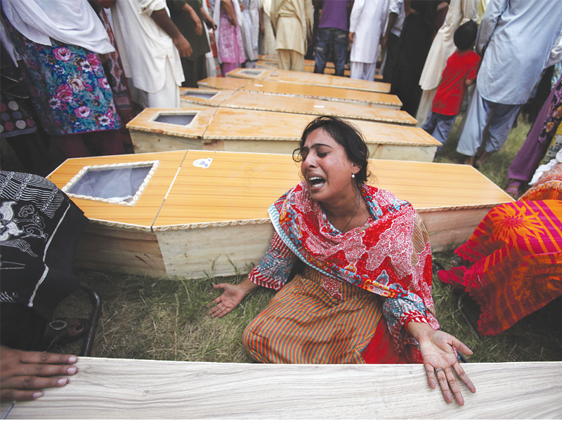 a woman mourns next to the casket of her brother who was killed in the twin suicide attacks photo reuters