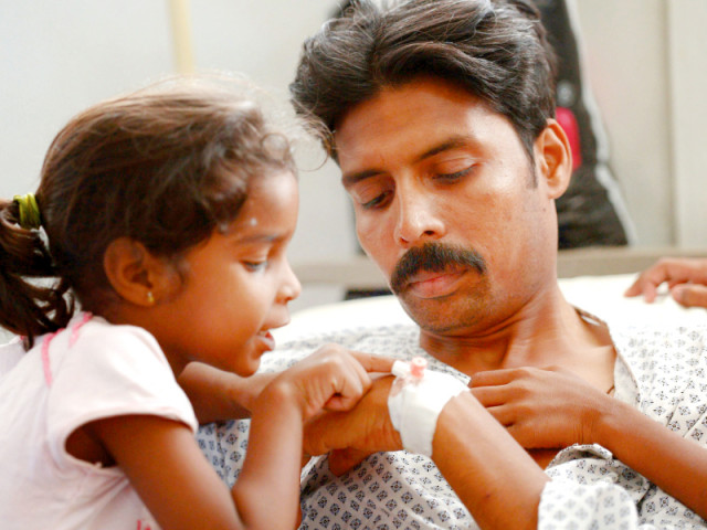 a daughter inquires the health of her father wounded during the attack in peshawar photo afp a daughter inquires the health of her father wounded during the attack in peshawar photo afp