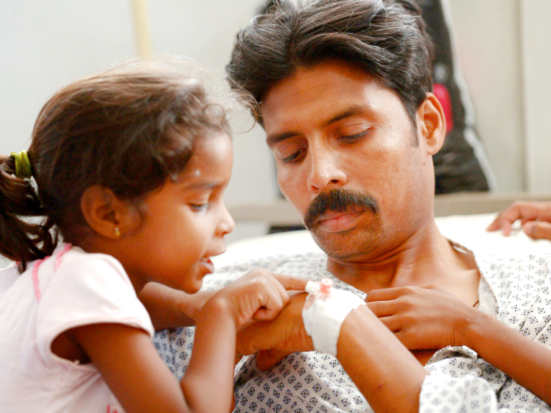 a daughter inquires the health of her father wounded during the attack in peshawar photo afp