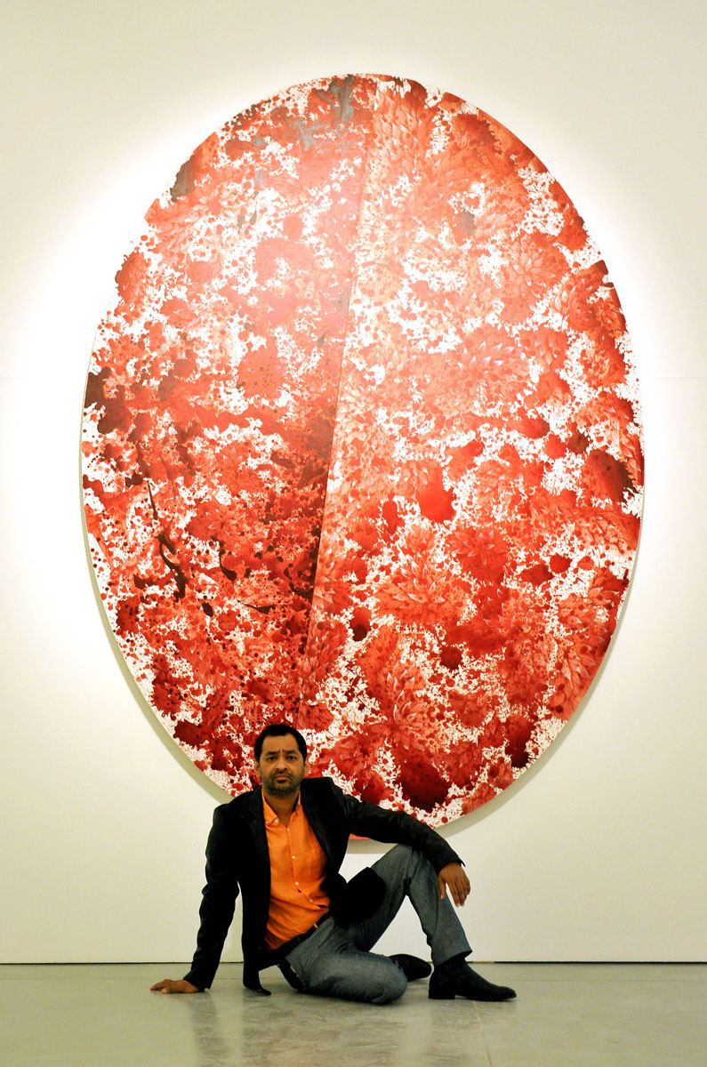 artist iman qureshi poses next to his workon september 23 2013 during the opening of his exhibition at the macro museum in rome photo afp