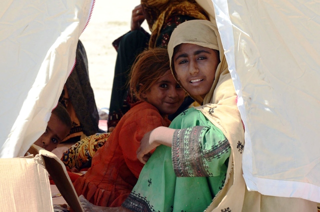 a pakistani earthquake survivor family sit in a tent near their collapsed mud houses in the earthquake devastated district of awaran on september 25 2013 photo afp